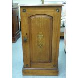 A late Victorian walnut bedside cabinet with a single panelled door, on a plinth  29"h  17"w