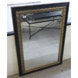 A modern mirror, the bevelled plate set in a painted and gilt sprayed frame  30" x 42"