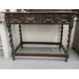 An 18thC and later country made stained oak and planked pine side table, the single, block front