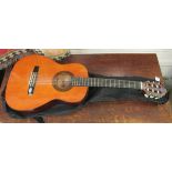 A Valencia Spanish six string acoustic guitar with a soft fabric carrying case