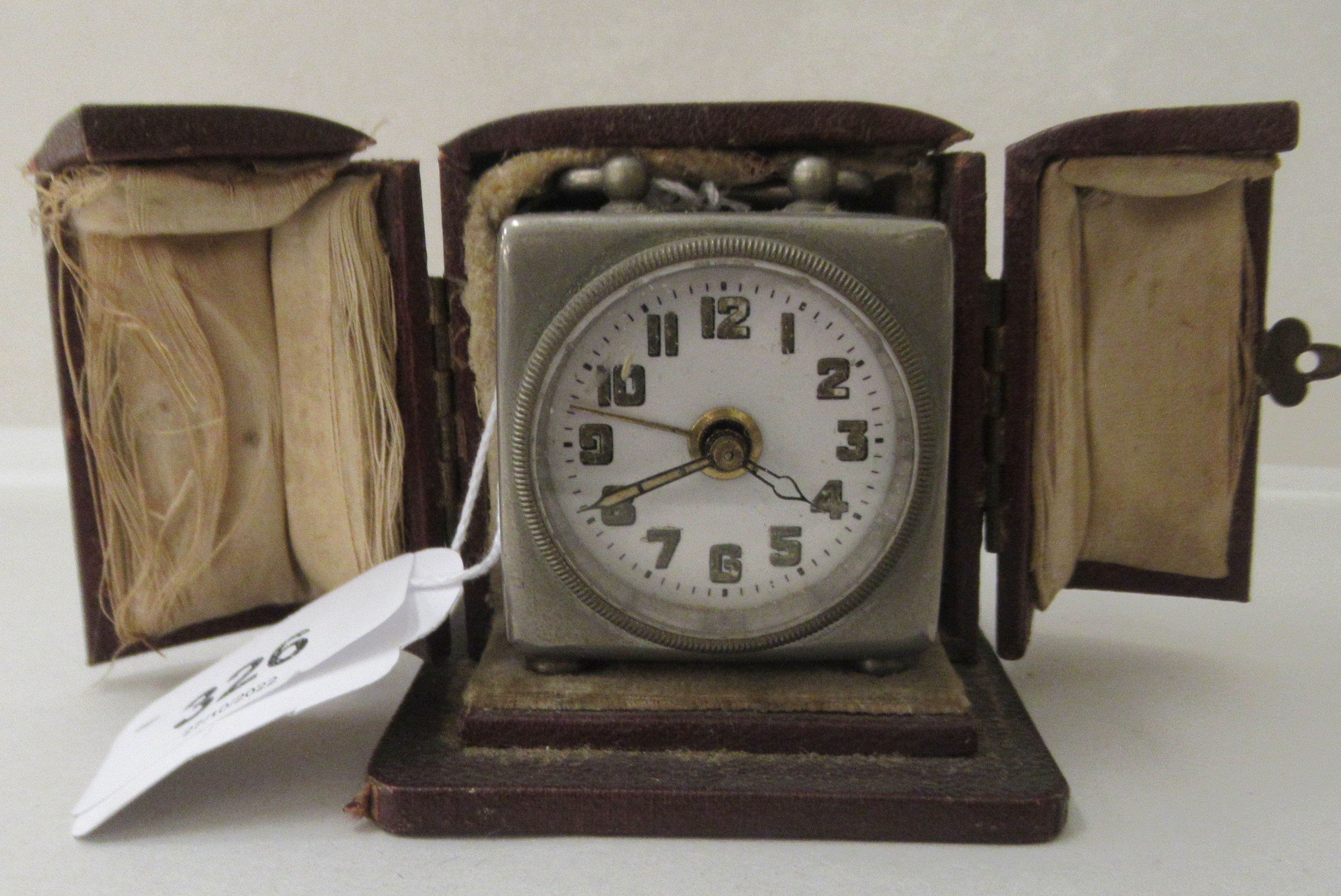 An Art Deco chromium finished cased carriage clock with an alarm; faced by an Arabic dial