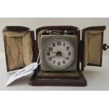 An Art Deco chromium finished cased carriage clock with an alarm; faced by an Arabic dial