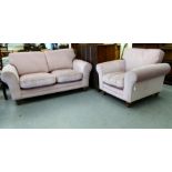 A modern two person settee of classic design with dusky pink upholstery and fitted cushions; and a