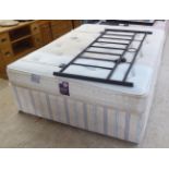 A Dreams divan bed base, Balaeric mattress and a tubular metal, black painted headboard  54"w