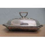 A silver entrée dish and cover of elongated octagonal form with gadrooned border ornament and a