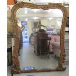 A late 19thC overmantle mirror, set in an ornate gilt gesso frame  66"h  54"w