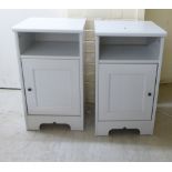 A pair of modern grey/cream coloured painted pine bedside chests, the open shelves over panelled