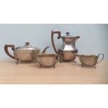 A matched four piece silver tea set, of elongated, octagonal, oval panelled outline, the teapot with