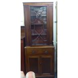 A late Victorian mahogany two section display cabinet with an astragal glazed door, over a drawer