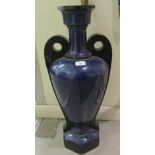 A late 19thC pottery blue glazed vase of baluster form with opposing handles  27"h