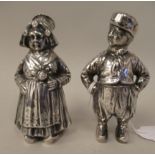 A pair of Continental silver novelty pepper pots, respectively fashioned as a standing Dutch boy and