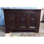 A 1930s Gothic inspired stained oak blanket chest with straight sides and a hinged lid, over a tri-