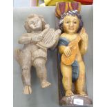 Two dissimilar carved wooden cherubic figures, on plinths  21"h