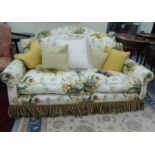 A Peter Dudgeon two person cottage design settee with scrolled arms, upholstered in floral patterned