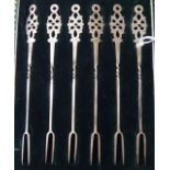 A set of six silver pickle forks with decoratively pierced terminals  Sheffield 1925  cased