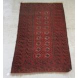 A Bokhara rug, decorated with two columns of nine octagonal guls, on a red ground  41" x 67"