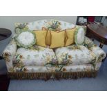A Peter Dudgeon two person cottage design settee with scrolled arms, upholstered in floral patterned