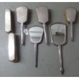 Seven similar engine turned silver backed dressing table items: to include a pair of hairbrushes;