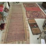 Three rugs: to include a (probably) North African example, decorated with repeating designs in