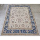 A Persian Mahal rug, decorated with stylised flora and foliage, on a cream coloured ground with a