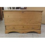 A late Victorian stained pine mule chest with a hinged lid and a drawer, raised on bracket feet