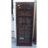 An early/mid 20thC mahogany cabinet with a full-height glazed panelled door, on a plinth  65"h  25"w