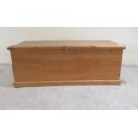 A late Victorian stained pine chest with a hinged lid, on a plinth  14"h  37"w