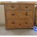 A late Victorian stained pine dressing chest with two short/two long drawers, raised on bun feet