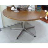 A 1970s teak coffee table, raised on splayed, cast metal pedestal base  20"h  34"dia