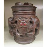 An Oriental carved wooden tobacco jar and cover, decorated with dragons  7"h