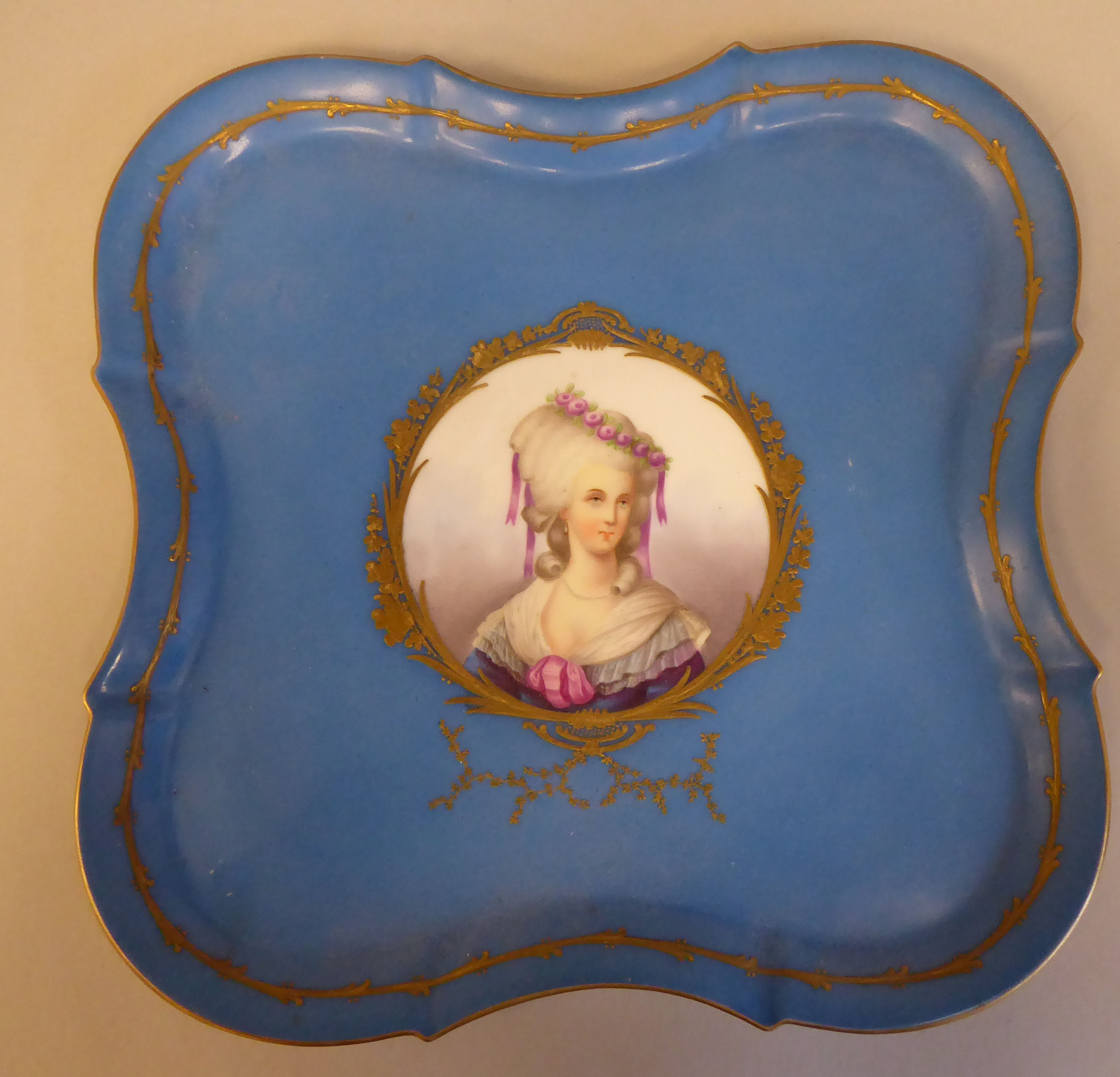 A 19thC Serves porcelain serpentine outlined cabaret tray, decorated with a vignette head and
