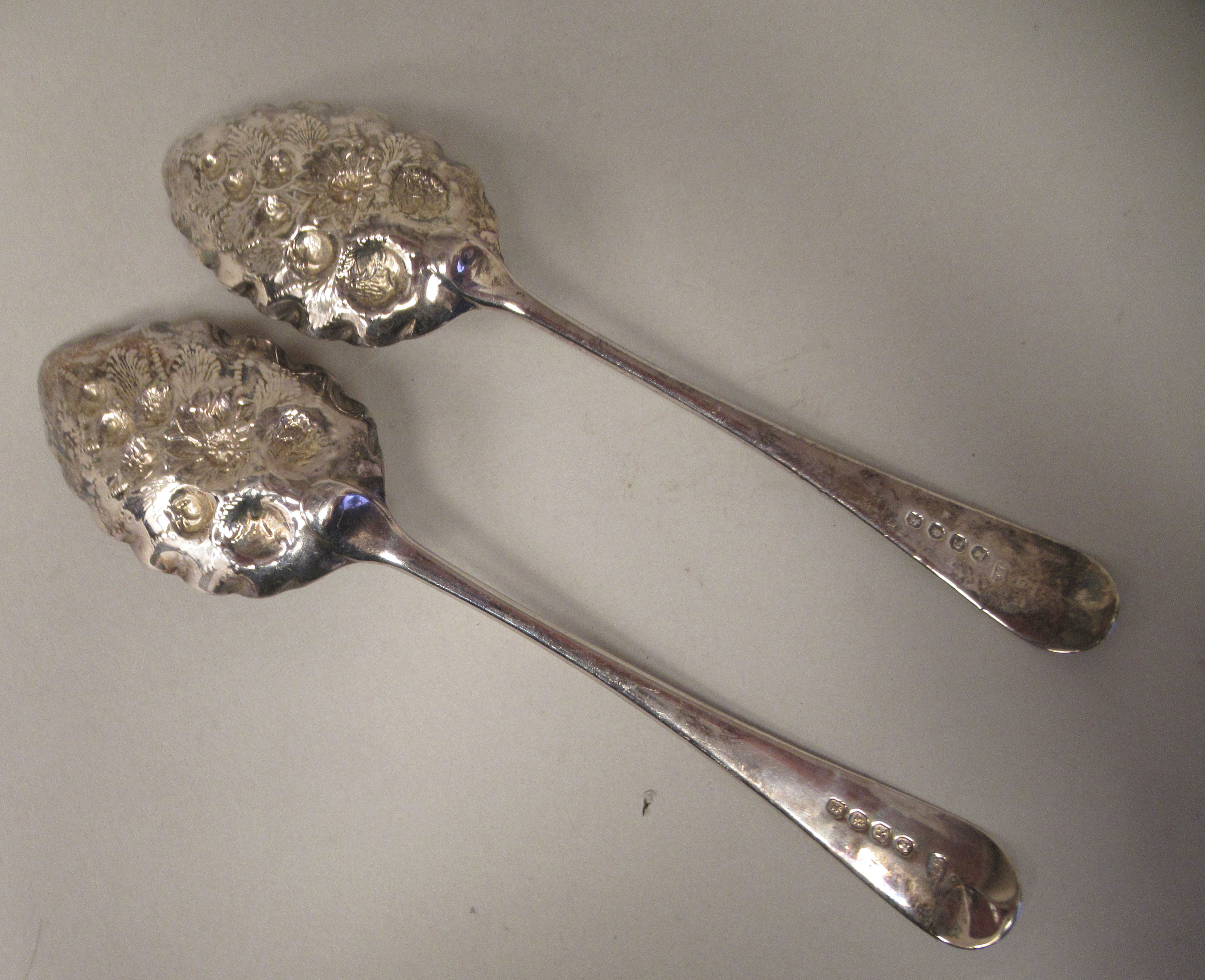 A pair of George III silver and parcel gilt Old English pattern berry spoons with foliate engraved - Image 2 of 4