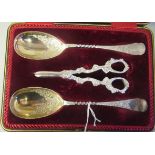 A pair of late Victorian silver plated fruit spoons with decoratively scroll engraved ornament;