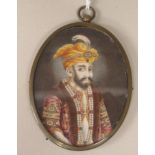 A late 19thC oval half length portrait miniature, a bearded man wearing Persian costume with