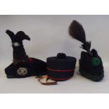 A military style black pill box hat with red piping  bears a Hobson & Sons (London) label and
