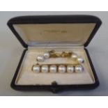 A gold coloured metal bar brooch, set with six inline pearls; and a pair of twin bead pearl drop