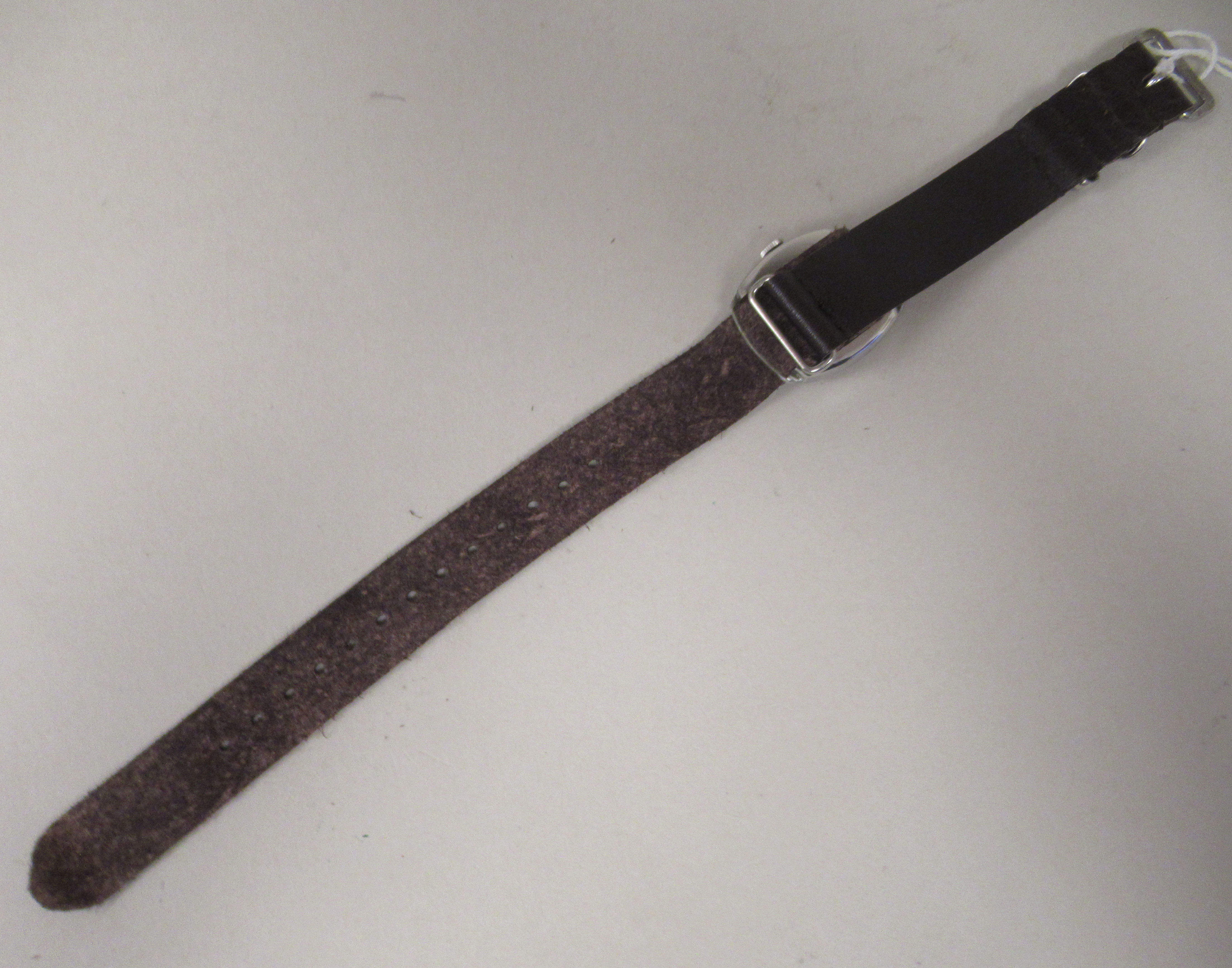 A 1940s Tudor stainless steel cased wristwatch, the movement faced by an Arabic dial, on a brown - Image 3 of 4