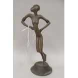 An African bronze standing female dancing figure with hands on hips and a domed, circular base  11"h