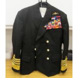 A Royal Navy submariners double-breasted tunic with emblems and braided sleeves, medal ribbons,