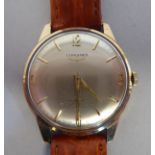 A Longines 9ct gold cased wristwatch, faced by an Arabic and baton dial, on a stitched mid brown