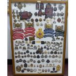 Over seventy military cap badges and other insignia, embroidered uniform identification badges and