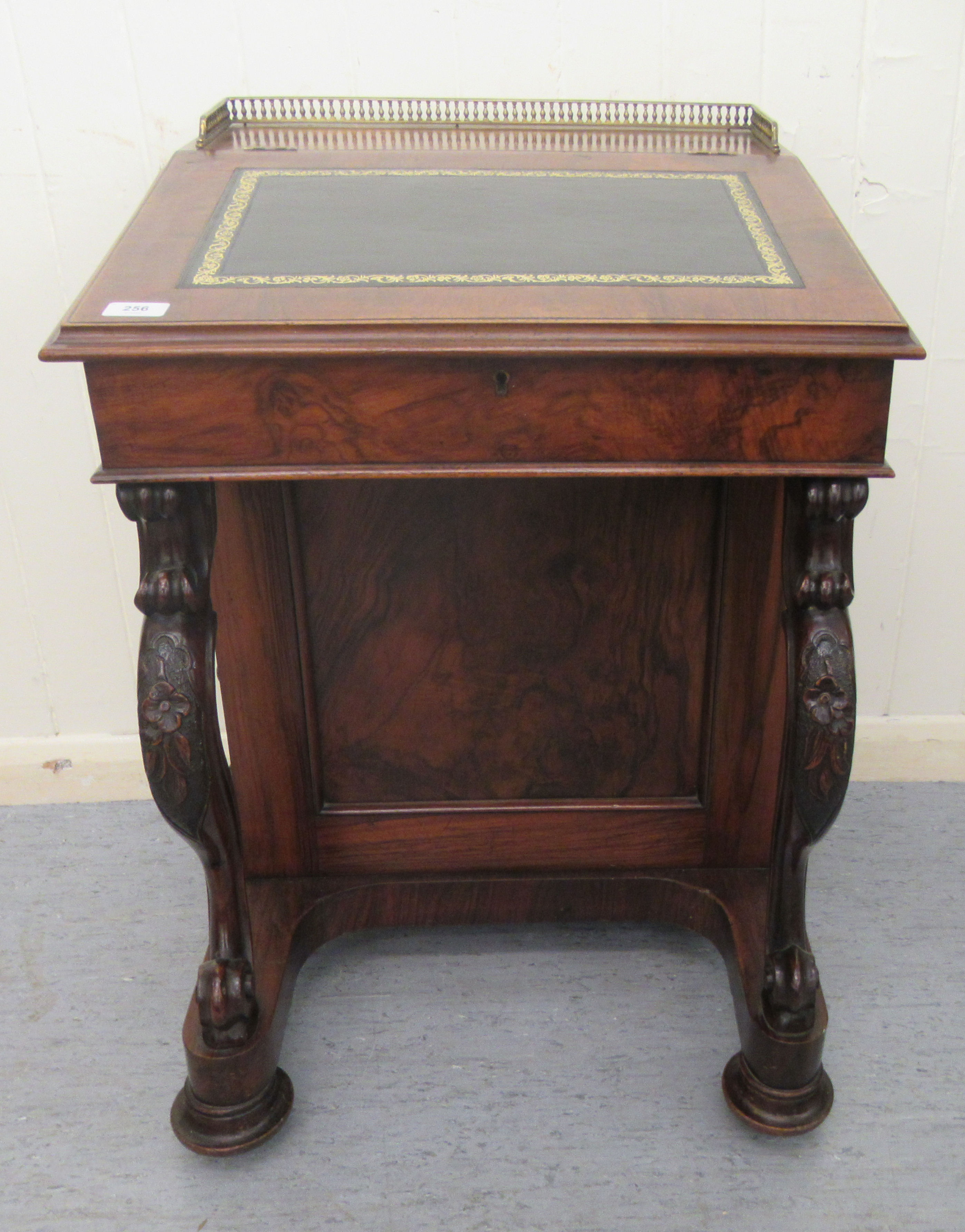 A mid Victorian walnut Davenport with a brass galleried top and an angled, hinged, tooled green hide
