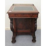 A mid Victorian walnut Davenport with a brass galleried top and an angled, hinged, tooled green hide