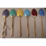 A set of six silver gilt coffee spoons with individually coloured, engine turned enamel bowl