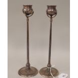 A pair of silver candlesticks, in the manner of Tiffany, each comprising a cauldron shaped socket in