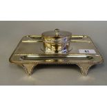 A Georgian style silver standish, the rectangular tray base with a gadrooned border, two pen