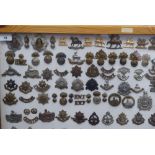 Over one hundred and twenty military cap badges and other insignia, some copies: to include The
