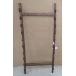 A mahogany wall rack for swords/sticks with provision for ten items  55"h  24"w