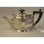 A late Victorian silver batchelors oval teapot with embossed garlands, drapes and demi-reeded