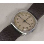 A 1940s Tudor stainless steel cased wristwatch, the movement faced by an Arabic dial, on a brown